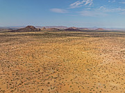Desert landscape with ed granite hills around the Brandberg Moun #1 Photograph by Sami Sarkis Photography