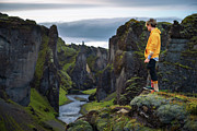 Young hiker standing at the edge of the Fjadrargljufur Canyon in Iceland #1 Photograph by Miroslav Liska