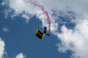 Golden Knights Skydiver with Red Smoke Against Blue Sky by Dave Koch Photograph by Dave Koch - Aircraft Photography