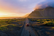 Gravel road at sunset with Vestrahorn mountain and a car driving, Iceland Photograph by Miroslav Liska