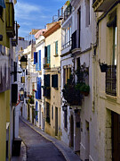Long White-Walled Alley with Blue Shutters, Sitges Old Town Photograph by Travel Essayist