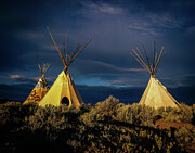 Teepees under a storm Photograph by Robert Niemeier