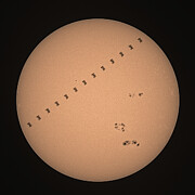 The International Space Station crossing in front of the sun Photograph by Brian Weber