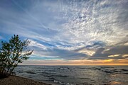 Tranquil Waters Capturing the Majesty of Sunset on the Shoreline Photograph by Travel Essayist