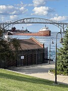 Up Bound Ship under the  Blue Water Bridge, Port Huron Michigan Photograph by Lloyd Gillies