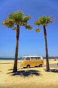 Vintage yellow Volkswagen camper van parked between palm trees on a sandy beach Photograph by Miroslav Liska
