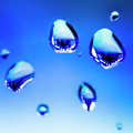 Blue water droplets on glass