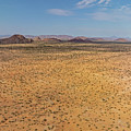 Desert landscape with ed granite hills around the Brandberg Moun #1 by Sami Sarkis Photography