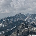 Majestic Mountain Range Under Cloudy Sky