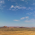 Desert landscape with ed granite hills around the Brandberg Moun by Sami Sarkis Photography