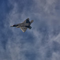 F-22 Banking Around Clouds by Raymond Salani III