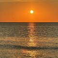 Golden Sunrise Over Tranquil Sea by Catherine Wilson