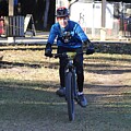 Man Riding Bicycle Through Park 3576 by Donn Ingemie