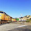 Sign of the Times -- Union Pacific Freight Train at a Railroad Crossing in Caliente, California Photograph by Darin Volpe