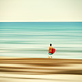 Surfer at the beach by Laura Zeid